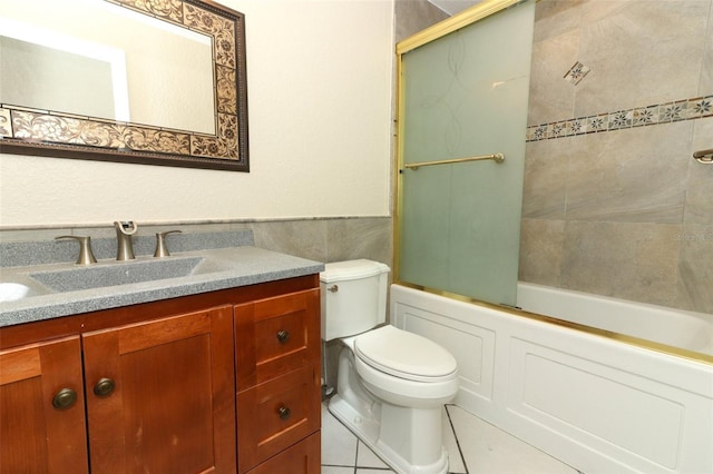 645 Peachwood Dr, Altamonte Springs, FL 32714 - bathroom with toilet, vanity, washtub / shower combination, tile patterned flooring, and tile walls