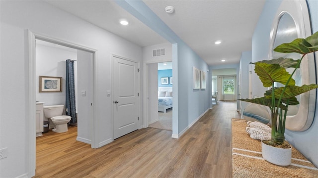 4246 Acoma Dr, Ormond Beach, FL 32174 - hallway with light wood-style flooring, baseboards, and recessed lighting