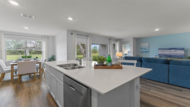4246 Acoma Dr, Ormond Beach, FL 32174 - kitchen featuring dishwasher, a sink, dark wood-type flooring, an island with sink, and light countertops