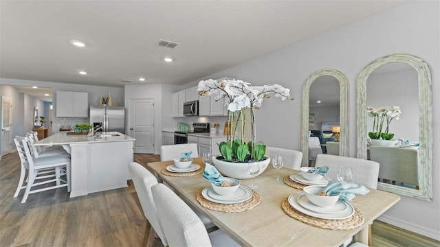 4246 Acoma Dr, Ormond Beach, FL 32174 - dining space with dark wood-style flooring, recessed lighting, arched walkways, and baseboards