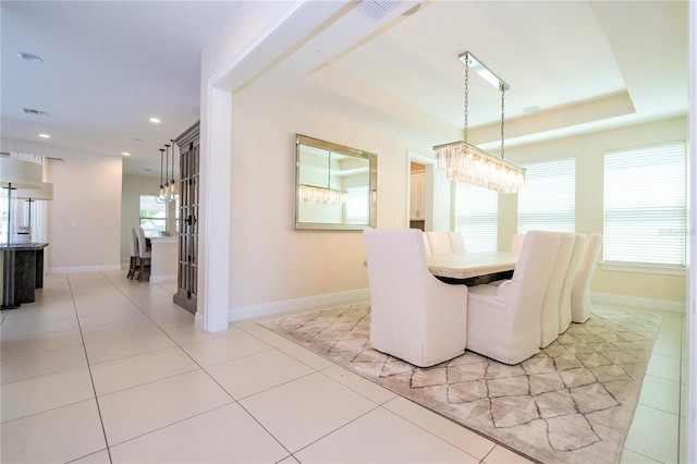 8419 Pippen Dr, Orlando, FL 32836 - dining room with light tile patterned flooring, a raised ceiling, baseboards, and recessed lighting