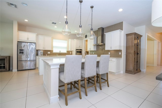 8419 Pippen Dr, Orlando, FL 32836 - kitchen with appliances with stainless steel finishes, wall chimney exhaust hood, recessed lighting, light countertops, and tasteful backsplash
