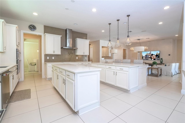 8419 Pippen Dr, Orlando, FL 32836 - kitchen featuring a large island with sink, wall chimney range hood, backsplash, light countertops, and recessed lighting