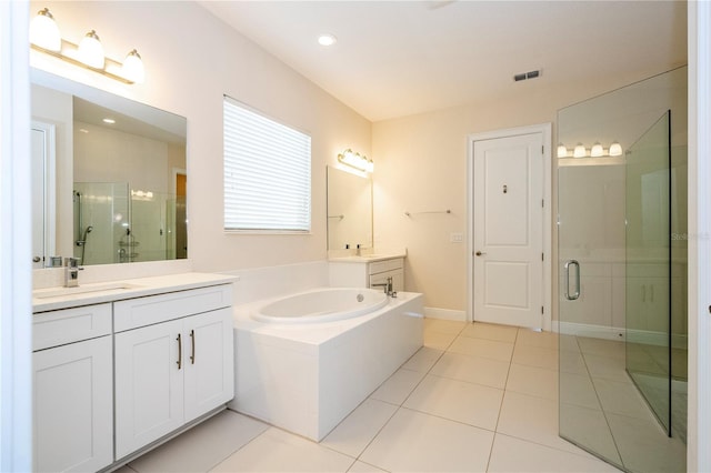 8419 Pippen Dr, Orlando, FL 32836 - bathroom with a shower stall, tile patterned floors, a bath, and two vanities