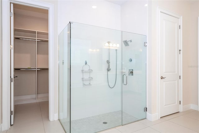 8419 Pippen Dr, Orlando, FL 32836 - bathroom featuring a shower stall, tile patterned floors, a spacious closet, and baseboards
