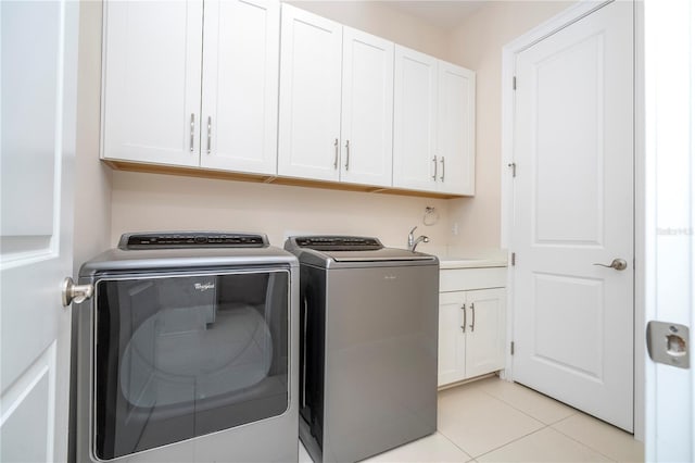 8419 Pippen Dr, Orlando, FL 32836 - laundry room with independent washer and dryer, cabinet space, and light tile patterned flooring