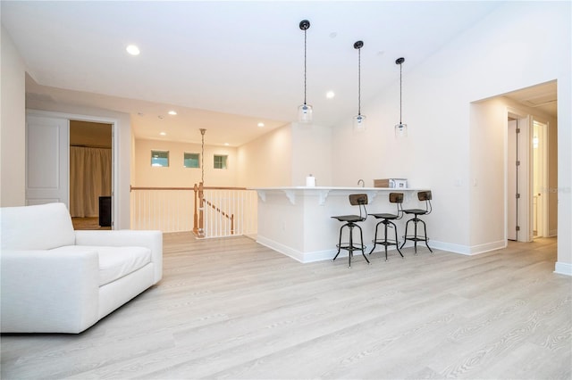 8419 Pippen Dr, Orlando, FL 32836 - living room featuring light wood-style floors, baseboards, recessed lighting, and bar