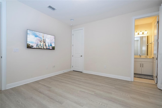 8419 Pippen Dr, Orlando, FL 32836 - unfurnished bedroom featuring light wood-style flooring, baseboards, and connected bathroom