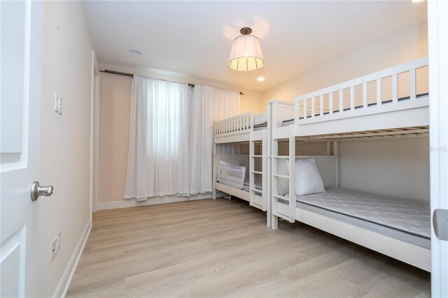 8419 Pippen Dr, Orlando, FL 32836 - unfurnished bedroom with light wood finished floors, baseboards, and recessed lighting