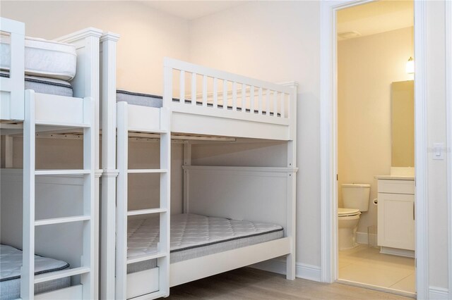 8419 Pippen Dr, Orlando, FL 32836 - unfurnished bedroom featuring ensuite bath, wood finished floors, and baseboards