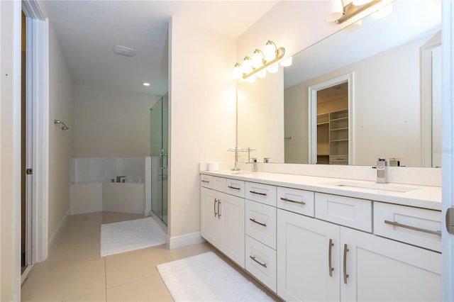 8419 Pippen Dr, Orlando, FL 32836 - bathroom with a stall shower, tile patterned flooring, double vanity, baseboards, and a walk in closet