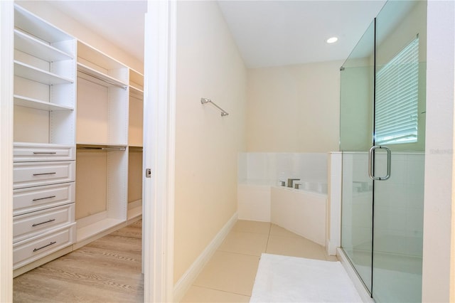 8419 Pippen Dr, Orlando, FL 32836 - full bath with a shower stall, a bath, a walk in closet, tile patterned floors, and recessed lighting