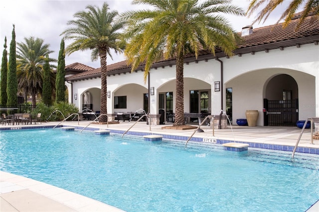 8419 Pippen Dr, Orlando, FL 32836 - community pool featuring a patio area