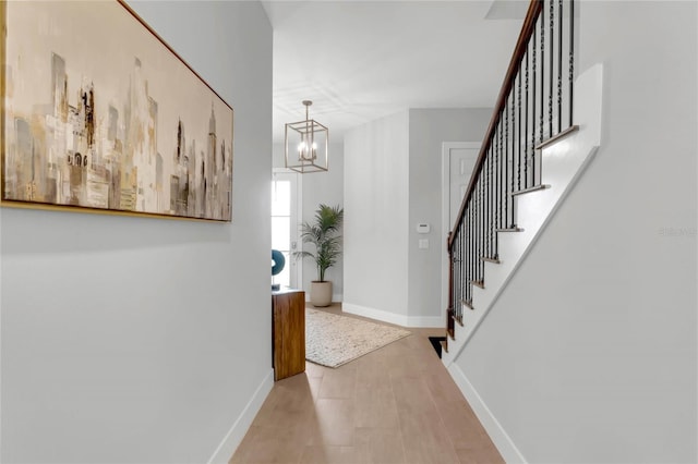 15947 Vetta Dr, Bella Collina, FL 34756 - foyer featuring stairs, baseboards, and a chandelier