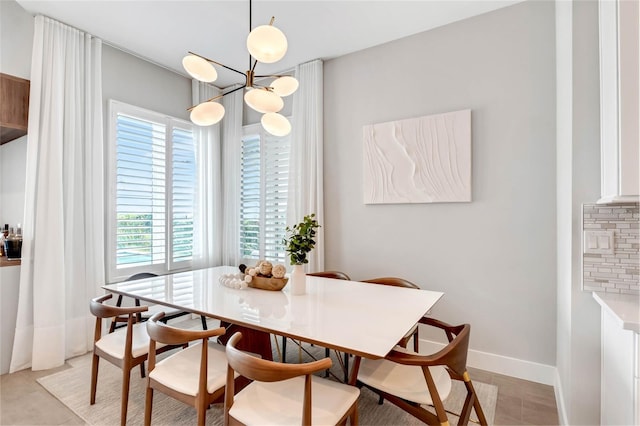 15947 Vetta Dr, Bella Collina, FL 34756 - dining space featuring a chandelier, light tile patterned floors, and baseboards