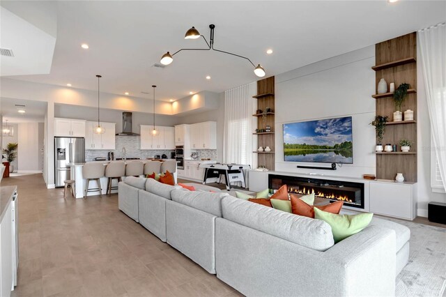 15947 Vetta Dr, Bella Collina, FL 34756 - living area with a warm lit fireplace and recessed lighting