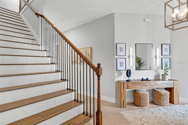 15947 Vetta Dr, Bella Collina, FL 34756 - stairway featuring a chandelier and baseboards