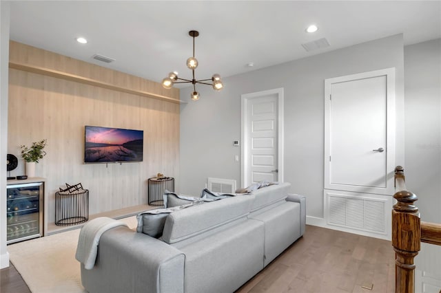15947 Vetta Dr, Bella Collina, FL 34756 - living area with wine cooler, a chandelier, wood finished floors, recessed lighting, and baseboards