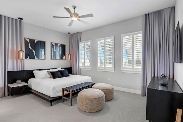 15947 Vetta Dr, Bella Collina, FL 34756 - bedroom with carpet floors, multiple windows, baseboards, and ceiling fan