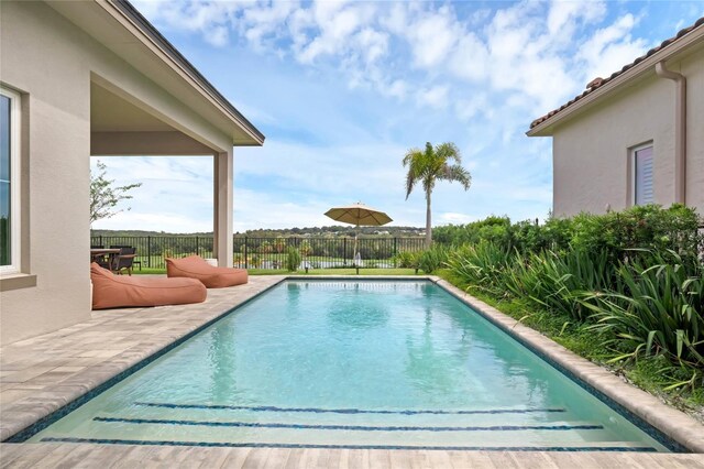 15947 Vetta Dr, Bella Collina, FL 34756 - view of swimming pool with a patio area