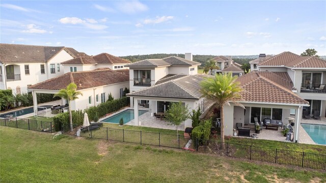 15947 Vetta Dr, Bella Collina, FL 34756 - back of property featuring outdoor lounge area, a patio area, a residential view, and a tiled roof