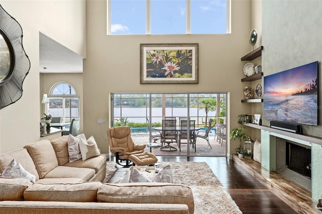 4536 N Landmark Dr, Orlando, FL 32817 - living area featuring a towering ceiling, dark wood-style floors, and a fireplace