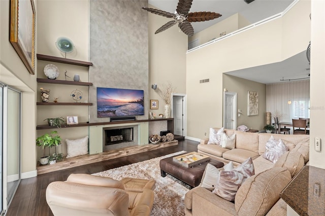 4536 N Landmark Dr, Orlando, FL 32817 - living area featuring wood finished floors, ceiling fan, a towering ceiling, a fireplace, and built in features