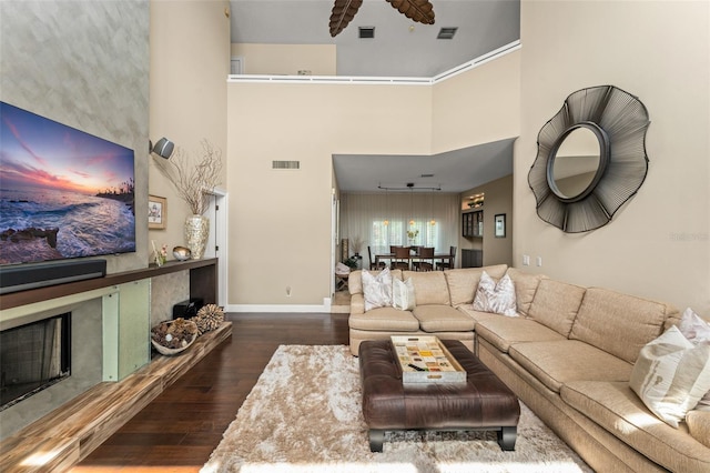 4536 N Landmark Dr, Orlando, FL 32817 - living room featuring wood finished floors, a towering ceiling, and a fireplace