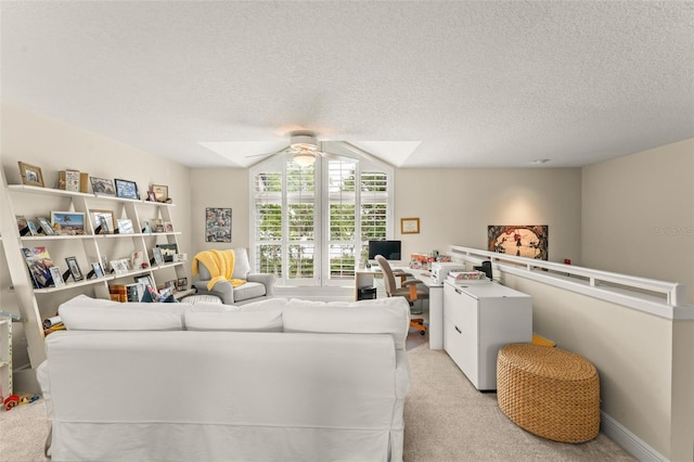 4536 N Landmark Dr, Orlando, FL 32817 - living area featuring ceiling fan, light colored carpet, a skylight, a desk, and a textured ceiling