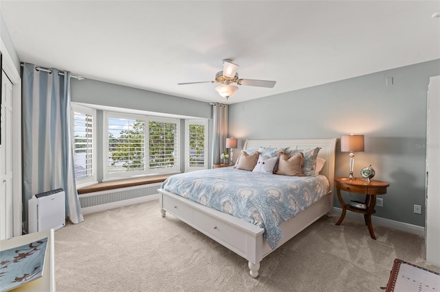 4536 N Landmark Dr, Orlando, FL 32817 - bedroom with light carpet, radiator heating unit, and a ceiling fan
