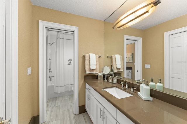 4536 N Landmark Dr, Orlando, FL 32817 - full bathroom with vanity, shower / tub combo, and a textured ceiling