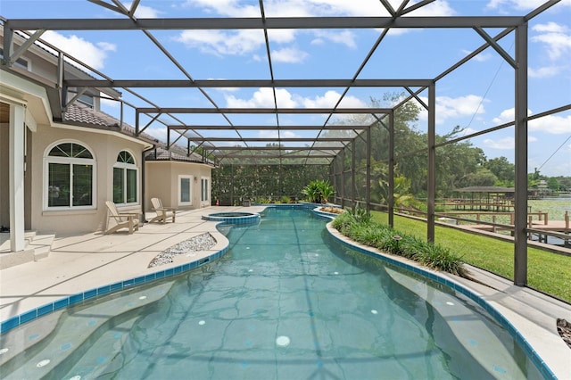 4536 N Landmark Dr, Orlando, FL 32817 - view of swimming pool featuring a pool with connected hot tub, a patio, a lanai, and a lawn