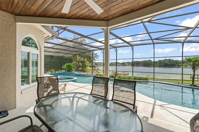4536 N Landmark Dr, Orlando, FL 32817 - view of swimming pool featuring a water view, outdoor dining area, a patio area, and a lanai