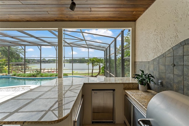 4536 N Landmark Dr, Orlando, FL 32817 - swimming pool with a water view, exterior kitchen, a lanai, and a patio area