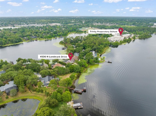 4536 N Landmark Dr, Orlando, FL 32817 - aerial view of property and surrounding area featuring a nearby body of water and a tree filled landscape