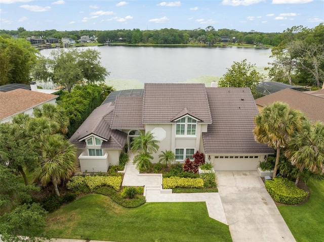4536 N Landmark Dr, Orlando, FL 32817 - view of front facade featuring a tile roof, stucco siding, concrete driveway, and a water view