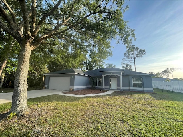 ranch-style home with concrete driveway, an attached garage, and stucco siding