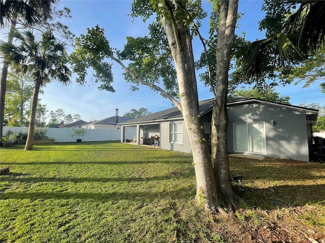 rear view of property featuring stucco siding