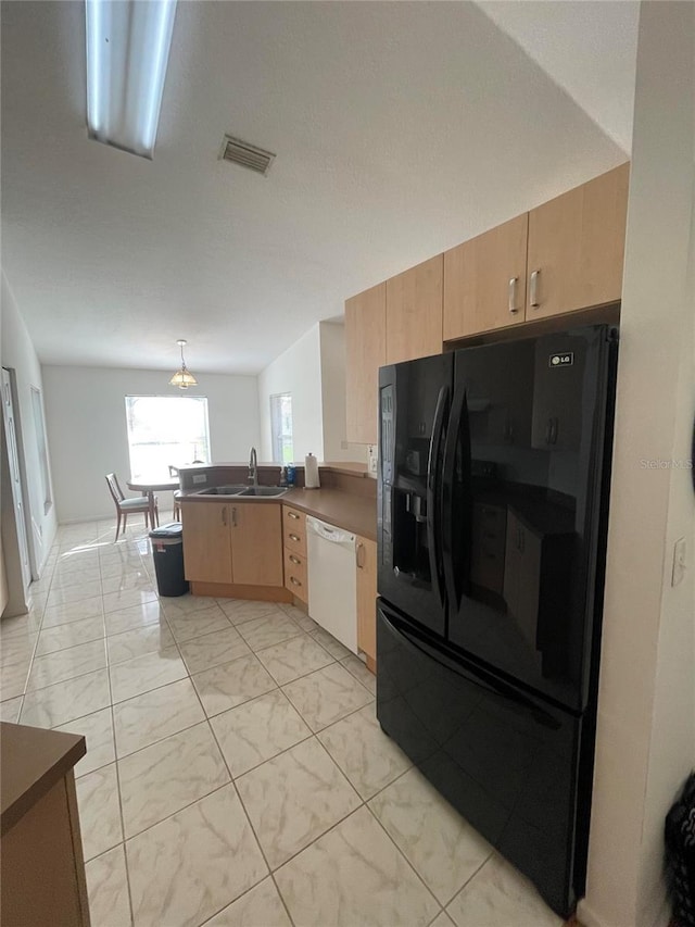 kitchen with black fridge with ice dispenser, dishwasher, a peninsula, a sink, and light marble finish flooring