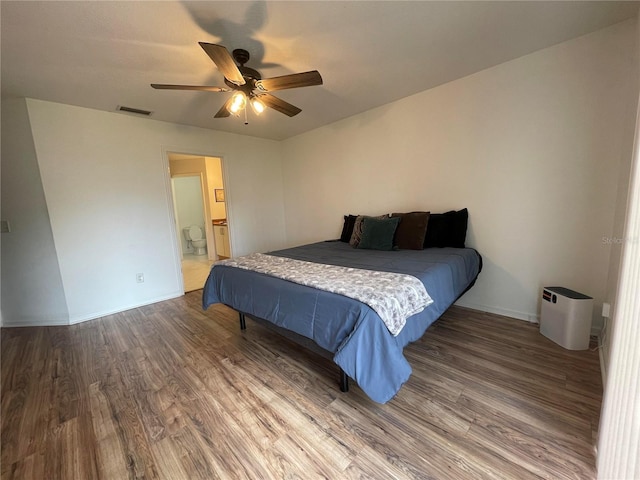 bedroom featuring wood finished floors, ceiling fan, and connected bathroom