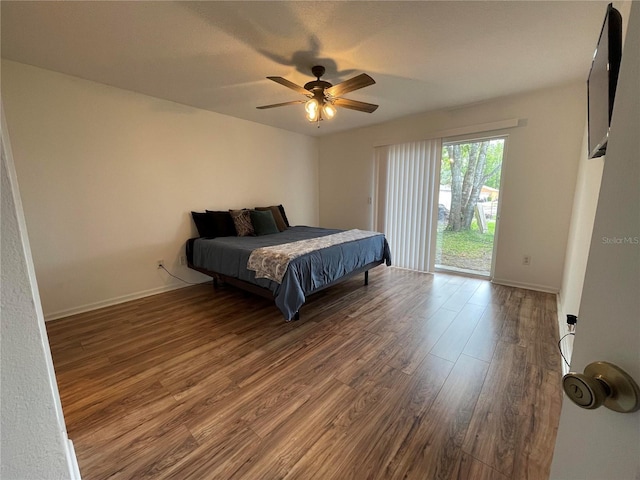 bedroom featuring access to outside, wood finished floors, ceiling fan, and baseboards