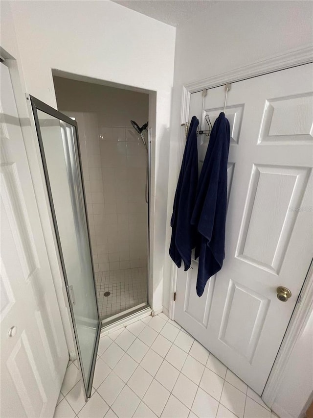 full bath with tile patterned flooring and a stall shower