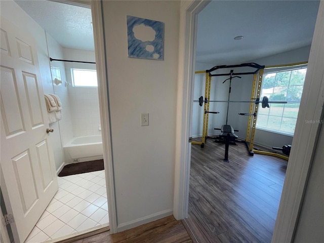 hall featuring wood finished floors and baseboards