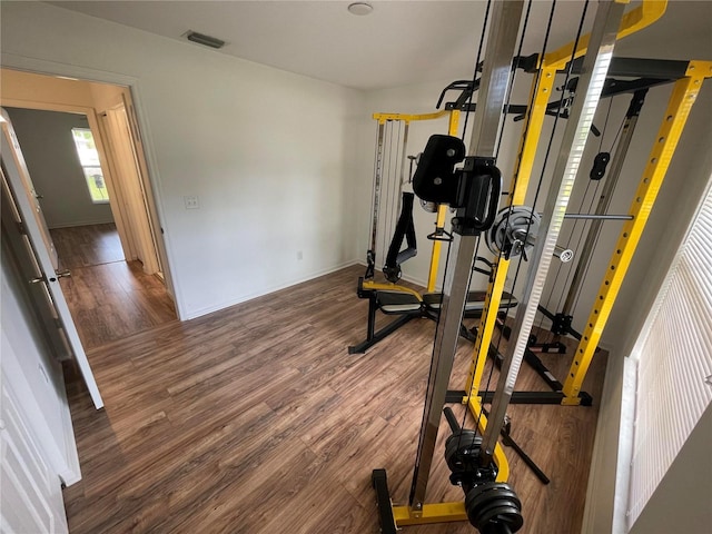workout area with wood finished floors and baseboards