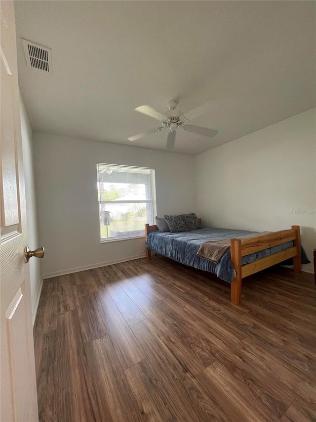 bedroom with wood finished floors, ceiling fan, and baseboards