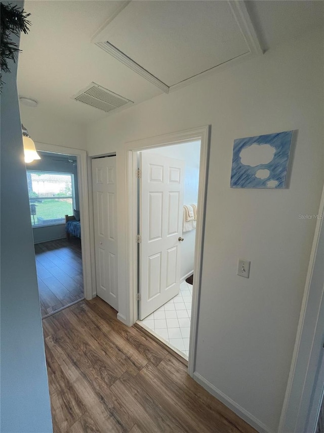 hallway with wood finished floors and baseboards