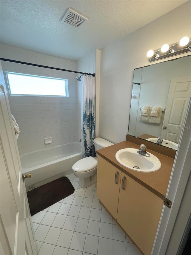 full bath featuring toilet, tile patterned flooring, a textured ceiling, shower / bath combo, and vanity