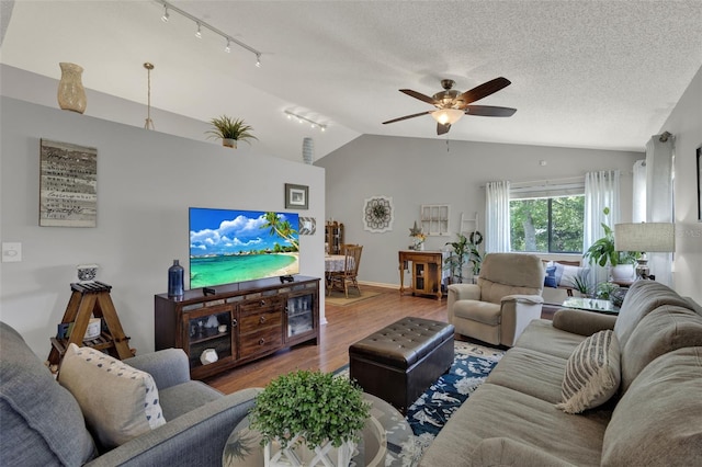 722 Ridgewood Way, Winter Springs, FL 32708 - living room featuring rail lighting, wood finished floors, ceiling fan, lofted ceiling, and baseboards