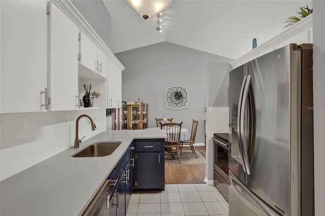 722 Ridgewood Way, Winter Springs, FL 32708 - kitchen with appliances with stainless steel finishes, a sink, vaulted ceiling, light countertops, and white cabinets