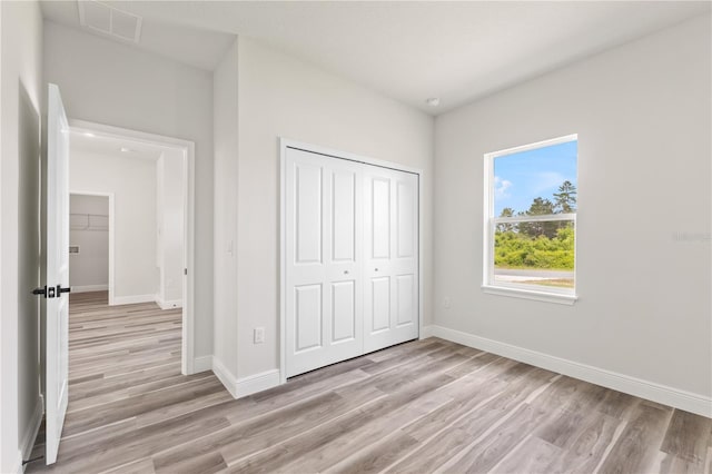 501 Marion Oaks Golf Way, Ocala, FL 34473 - unfurnished bedroom featuring light wood-style floors, a closet, and baseboards